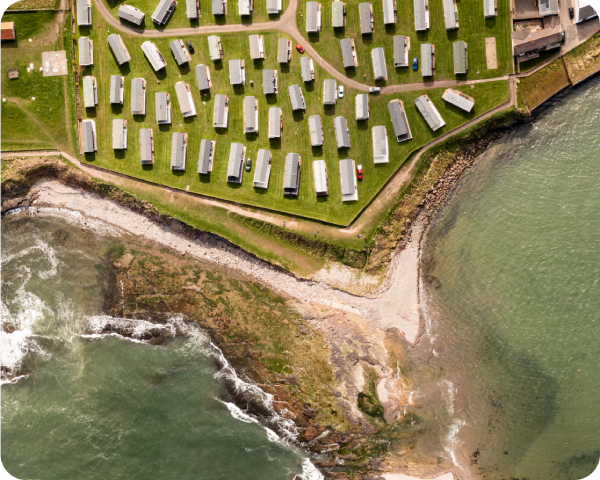 aerial-view-directly-above-a-large-static-caravan-2024-05-08-16-11-15-utc